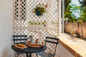 a table with a tea kettle and donuts on a patio at Casa Vacanze Vento del Sud in Porto Cesareo