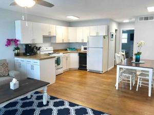 a kitchen and living room with a table and a refrigerator at Sailfish Suites - 11 - pet friendly in Stuart