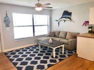 a living room with a couch and a table at Sailfish Suites - 11 - pet friendly in Stuart +24 photos