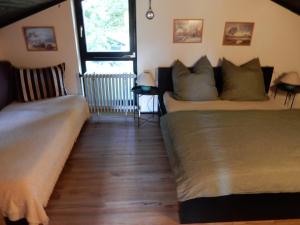 a bedroom with two beds and a window at Haus am Wald in Lissendorf