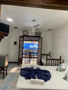 a bedroom with a bed and a tv and a room at Pousada Aqui é Para-Ti in Paraty +29 photos