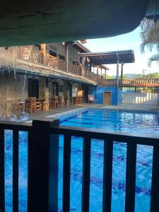 a large swimming pool in front of a house at Pousada Aqui é Para-Ti in Paraty