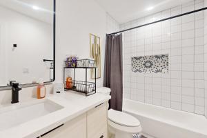 a bathroom with a tub and a toilet and a sink at Lago Vista Hideaway in Lago Vista +16 photos