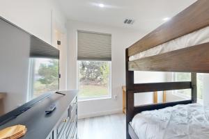 a bedroom with a bunk bed next to a window at Lago Vista Hideaway in Lago Vista