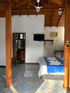 a bedroom with a bed and a flat screen tv at Pousada Aqui é Para-Ti in Paraty +27 photos