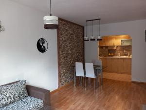 a living room and kitchen with a table and chairs at Nana's apartment in Varna City