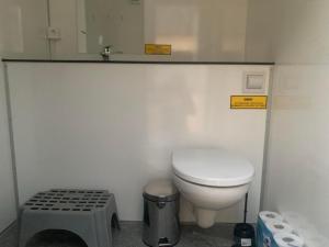 a small bathroom with a toilet and a sink at Glamping with outdoor wood-fired hot tub in Vissenbjerg