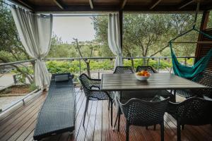 a wooden deck with a table and chairs on a porch at Jade na Murter in Murter