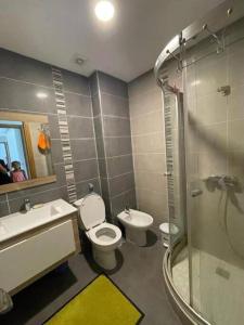 a bathroom with a toilet and a sink and a shower at Appartement résidence -Sidi Rahal in Sidi Rahal