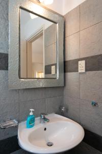 a bathroom with a white sink and a mirror at Mare Nostrum Studios in Kamarai +59 photos