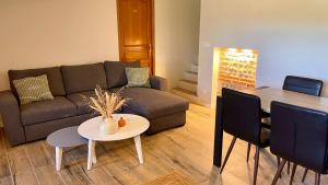 a living room with a couch and a table at Le Gîte de Cousal in Esperce