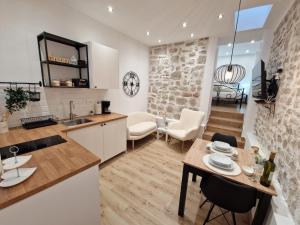 a kitchen and living room with a table and chairs at Small house Saint Michael in Šibenik
