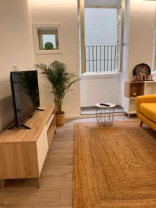 a living room with a tv and a couch at Valma GuestHouse in Viana do Castelo