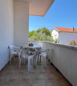 a table and chairs on a balcony with a view at Apartment Lavanda in Starigrad