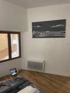 a white room with a fan and a window at Hébergement Seillans in Seillans