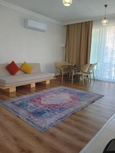 a living room with a couch and a table at GREEN HiLL DEFNE APART in Kas