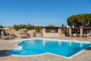 a swimming pool in the middle of a resort at Hotel Swiss Home in Naousa