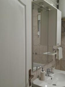 a bathroom with a sink and a mirror at Vacanza apartment in Mostar +24 photos