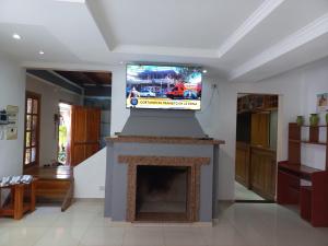 a living room with a tv on top of a fireplace at Rincón soñado para 8 personas in Puerto Iguazú