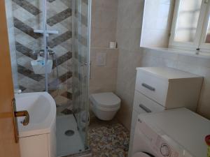 a bathroom with a shower and a toilet and a sink at Apartment Tacoma in Vrsar +15 photos