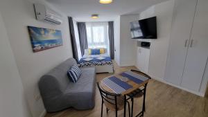 a small living room with a couch and a table at Diana Playa in Benalmádena