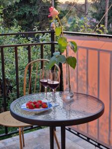 a table with a glass of wine and a plate of fruit at Apartament Fort Owcza Góra in Kłodzko