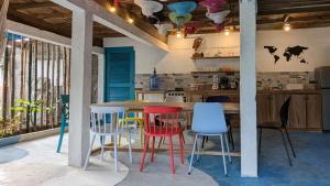 a kitchen with a table and some colorful chairs at Casa Pelicano in Bocas del Toro