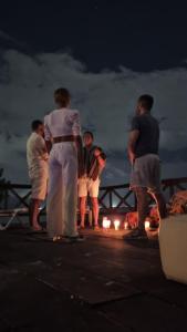 a group of people standing on a pier at night at On The Beach Seaside Sunrise Haven 4 Sea View in Cancún