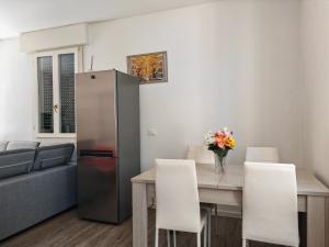 a living room with a table and a refrigerator at Goldmine Guest House 1 in Venice