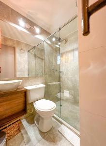 a bathroom with a toilet and a sink and a shower at Hotel Posada de Santa Elena in Tunja +34 photos