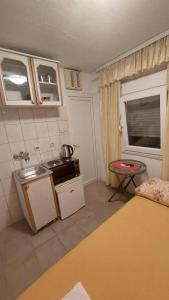 a small kitchen with a sink and a stove at Apartments Bojanic in Bar