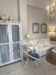 a living room with a couch and a chair at Casita Boutique en la playa in Sant Antoni de Calonge