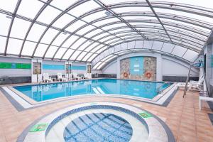 a large swimming pool with a glass ceiling at Holiday Inn Hefei by IHG in Hefei