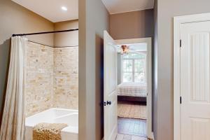 a bathroom with a tub and a walk in shower at Water's Edge Holmstead in Lake Lure +40 photos