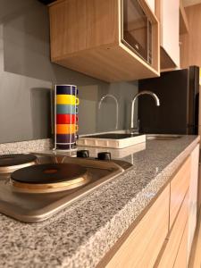 a kitchen with a counter top with a cup on it at Belmonte Studio 311 in Armenia