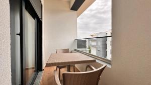 a balcony with a table and chairs and a window at Sublime nr9 in Ulcinj +7 photos