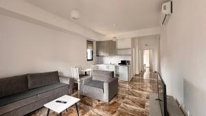 a living room with a couch and a kitchen at Sublime nr9 in Ulcinj