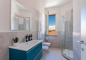 a bathroom with a sink and a toilet and a window at Tower View luxury apartment on the River in Pisa +18 photos