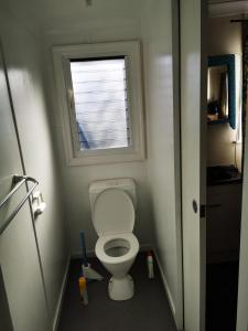a small bathroom with a toilet with a window at Affordable and convenient accommodation in Toowoomba
