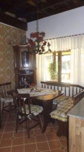 a dining room with a wooden table and chairs at Casa dentro da floresta in Campos do Jordão