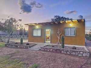 a small house with a statue in front of it at Cabaña Los Cardones in Campanas