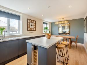 a kitchen with a large island and a table at Station Street Apartment in Cockermouth