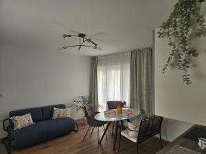 a living room with a blue couch and a table at Apartment Relax in Raskrižje