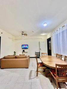 a living room with a couch and a table at 2BR Kelsey Haven With Balcony in Davao City
