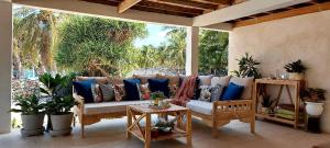 a couch on a porch with pillows on it at Ocean Park in Nembrala