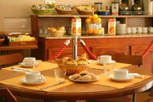 a table with a basket of bread on it at Hotel le Dauphin in Ajaccio