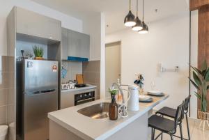 a kitchen with a sink and a stainless steel refrigerator at Trion Kuala Lumpur in Kuala Lumpur +110 photos