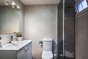 a bathroom with a toilet and a sink and a shower at Sarria Attic in Barcelona