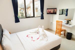 Postel nebo postele na pokoji v ubytování Suardana Inn's