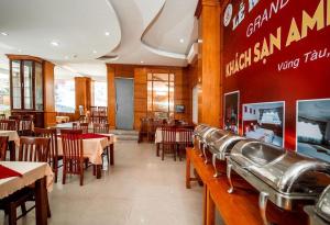 a dining room with tables and chairs in a restaurant at Amis Hotel VT by BAY LUXURY in Xã Thang Tam +19 photos